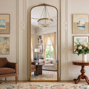 Aurelia antique gold ornate arched full-length mirror in a living room