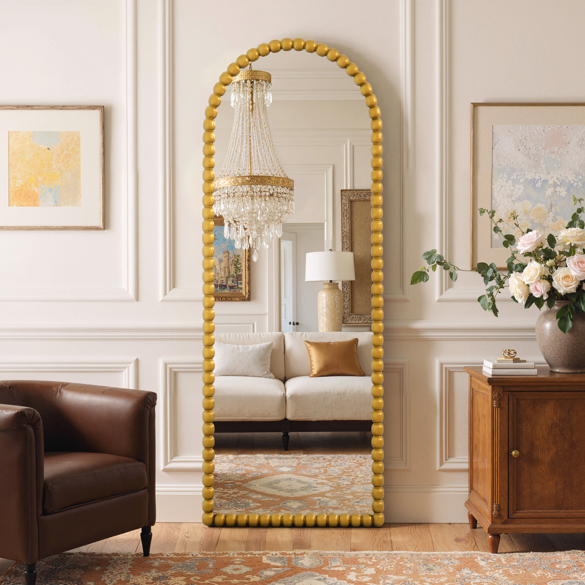 Delphine antique gold beaded arched full-length mirror in a living room