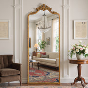 Vivienne antique gold floral crest full-length mirror in a living room