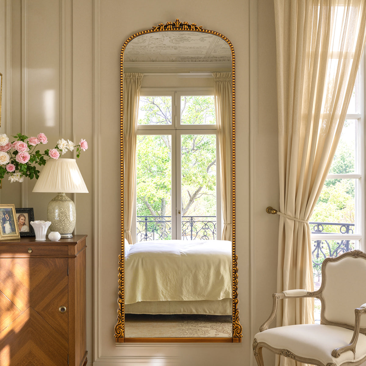 Aurelia antique gold ornate arched full-length mirror in a bedroom