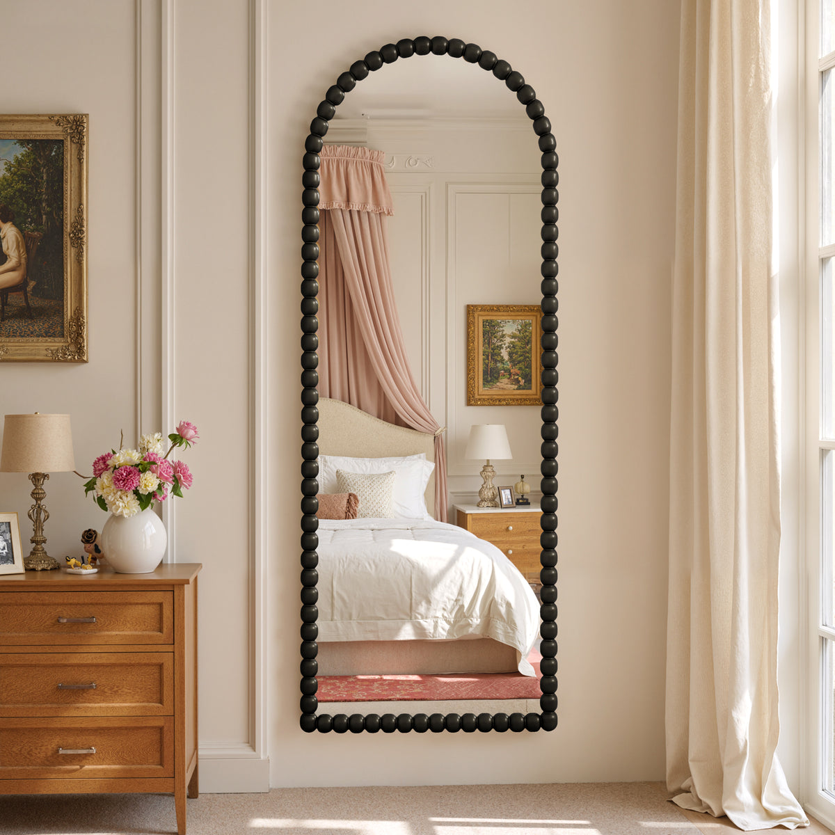 Delphine black beaded arched full-length mirror in a bedroom