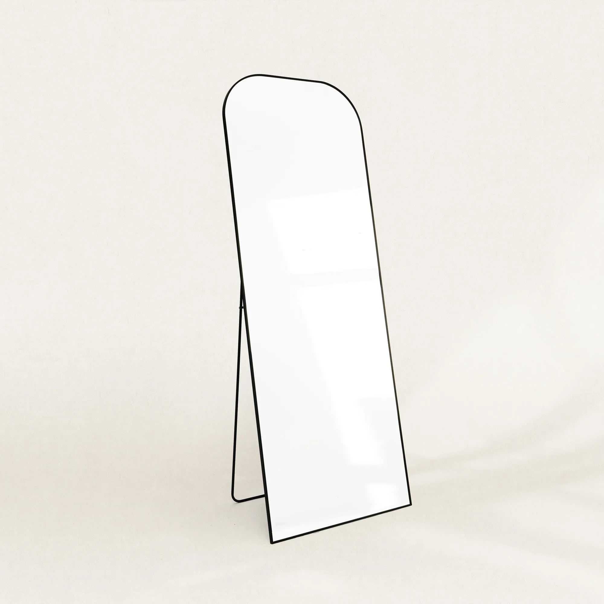 Elliot black curved full-length mirror on its folding stand