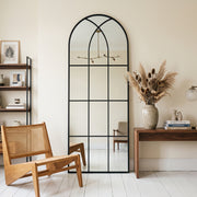 August black full-length windowpane mirror, 24W x 65H, in a furnished interior