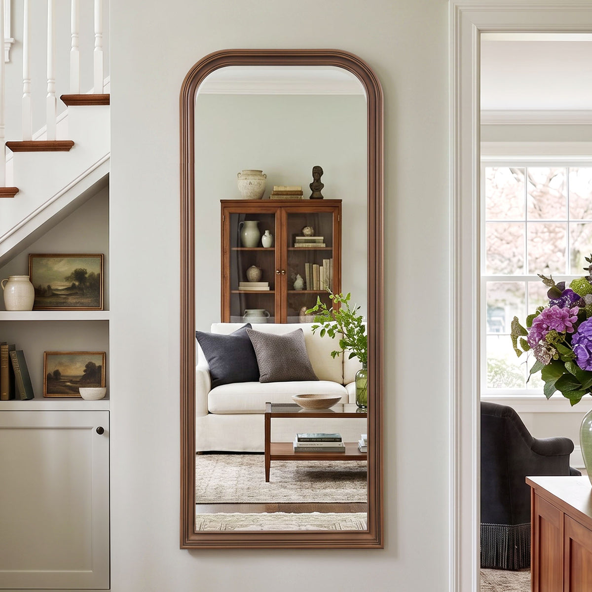 Estelle antique bronze full-length mirror mounted beside a staircase