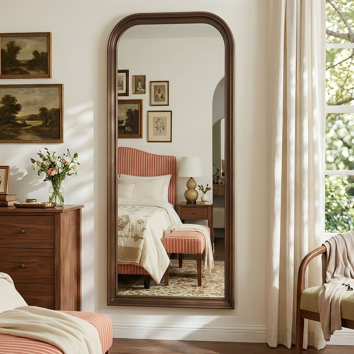 Estelle antique bronze full-length mirror mounted on a bedroom wall