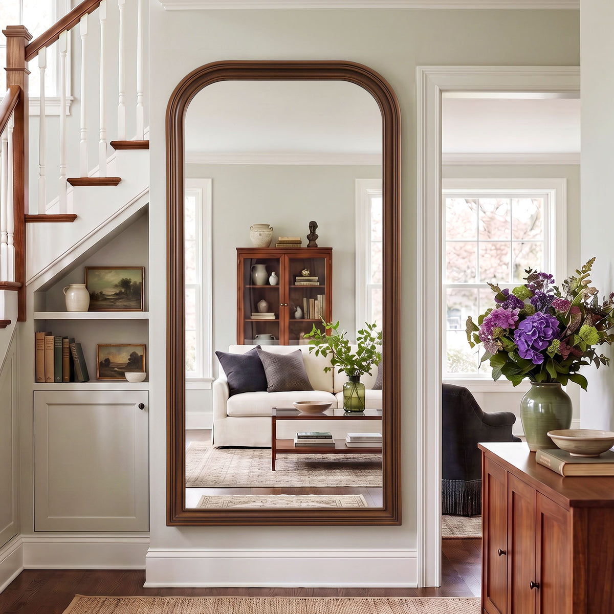 Estelle antique bronze full-length mirror mounted beside a staircase
