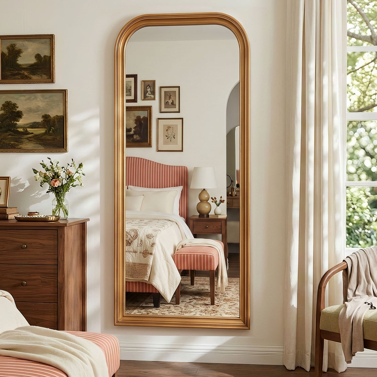 Estelle antique gold full-length mirror mounted on a bedroom wall