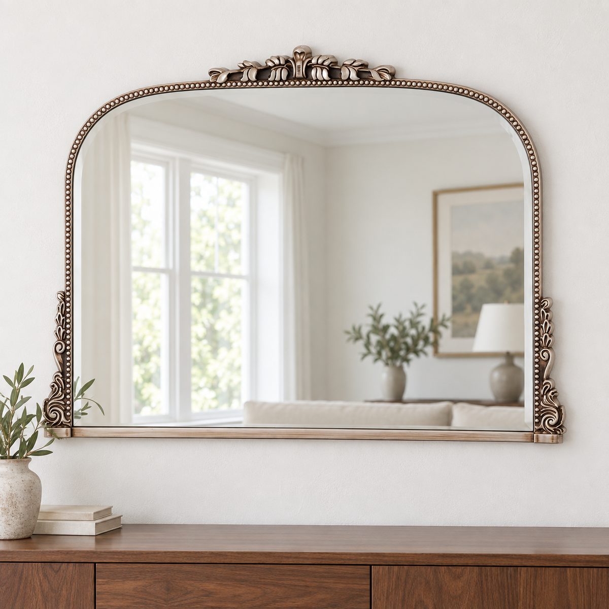 Harriet antique silver ornate wall mirror above a wooden console in a vintage-inspired interior